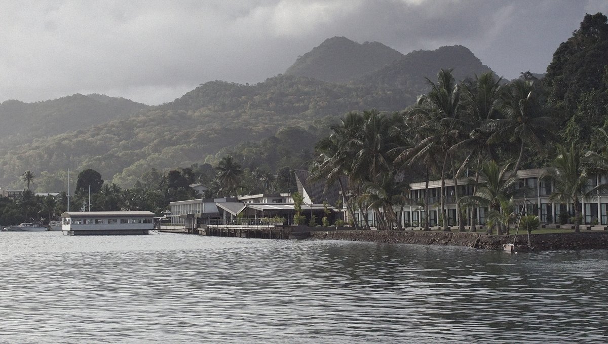 Lami Bay in Fiji A photo of Lami Bay in Fiji, showing a hotel by the water with palm trees in the foreground