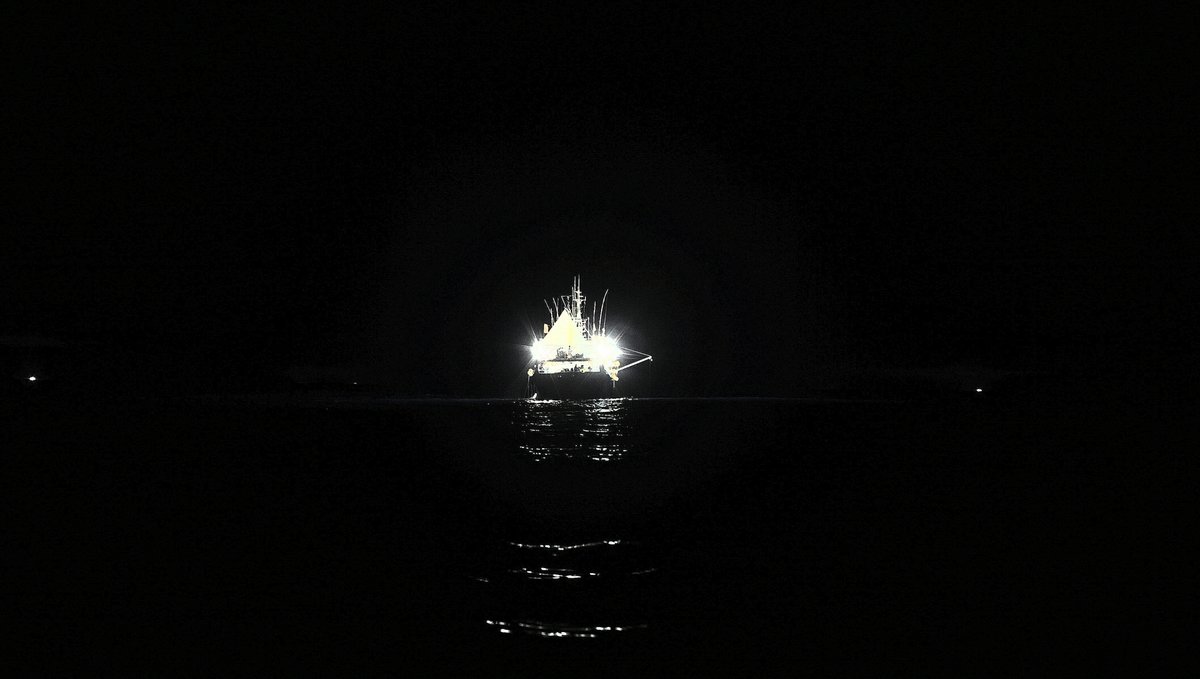 chinese squid fishing fleet on the north pacific ocean at night