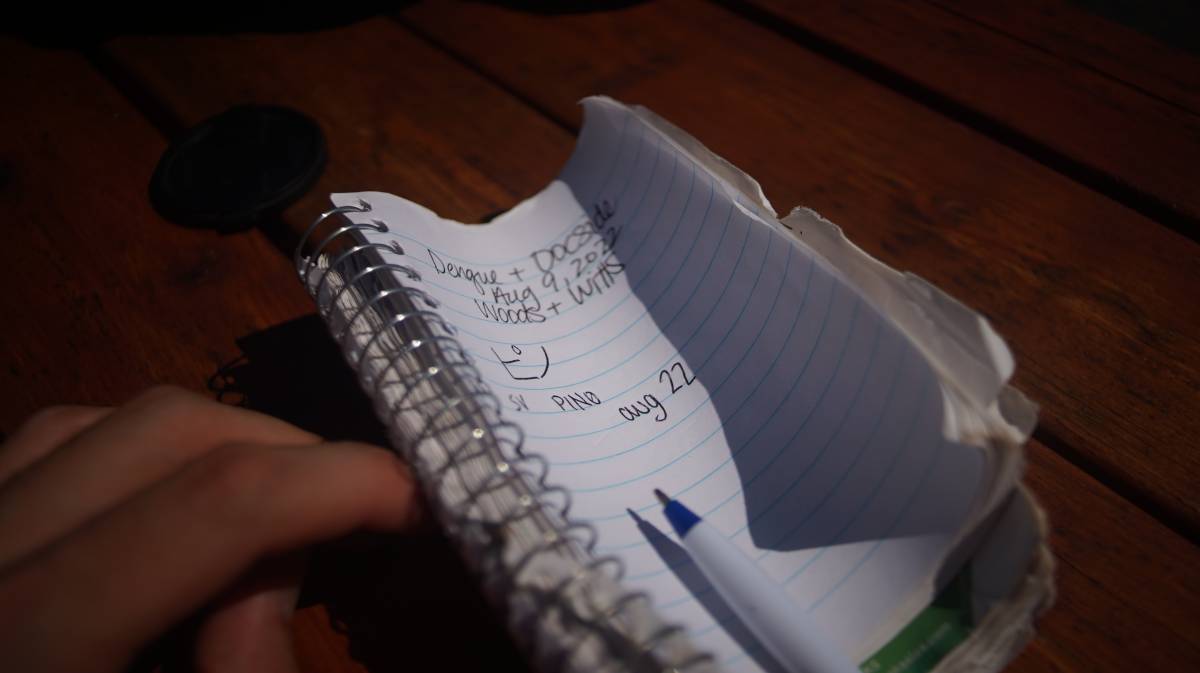 a notebook with dates and boat names inscribed on its pages