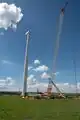 A crane prepares to hoist a wind turbine blade at the Kipeto Wind Park construction site in Kajiado county.