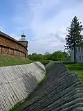 Defensive moat with fortified slopes