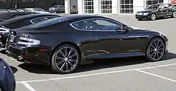 Rear-three quarters view of a black Virage with its black interior
