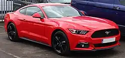 Front three-quarters view of a light red coupe