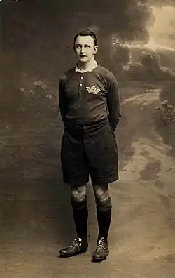 full body shot of Johnnie Wallace wearing his playing strip and boots