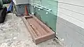 The place for ablution located outside against a wall of the surau.