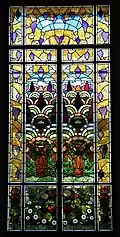 Chateau Laurens glass window with floral pattern in private living room