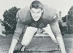 Alex Karras in a jersey and on his hands and toes, as if about to rush a passer.