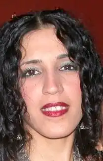 close-up of Azam Ali's face, grinning directly at camera