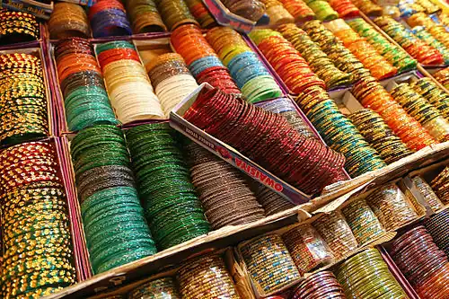Image 3 Bangles Photograph: Muhammad Mahdi Karim Bangles on display in Bangalore, India. These rigid bracelets are usually made from metal, wood, or plastic and are traditionally worn by women in India, Nepal, Pakistan, and Bangladesh. In India, it is a common tradition to see a new bride wearing glass bangles at her wedding and the honeymoon will end when the last bangle breaks. More selected pictures
