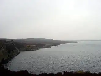 A lake with a rocky shoreline