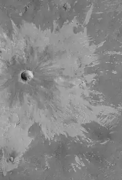 Bright rays caused by impact throwing out a bright lower layer. Some bright layers contain hydrated minerals. Picture taken with Mars Global Surveyor, under the MOC Public Targeting Program.