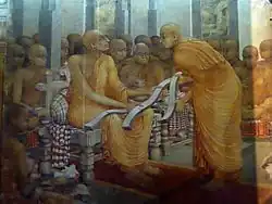 Buddhaghosa with three copies of Visuddhimagga