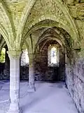 View of the chapter house, showing the three remaining windows in the east wall.
