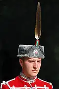 Headgear: kalpak with eagle feather and Alexander star