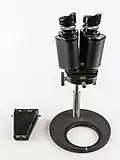 Zeiss; fixed magnification which can be adjusted by fitting new objective lenses.