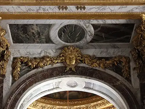 Baroque mascaron in the Hall of Mirrors, Palace of Versailles, designed by Jules Hardouin-Mansart, 1678-1684[34]