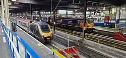 Caledonian Sleeper class 92 (right) Avanti West Coast class 221(left) at London Euston in 2023