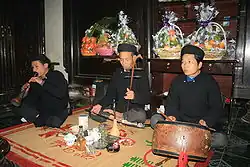 Image 14A trio of Vietnamese musicians performing together. The man on the far left plays kèn đám ma, the man in the middle plays the đàn nhị and the man on the right plays the trống chầu. (from Culture of Vietnam)