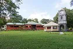 Entrance view of the museum, a large traditional house with gardens surrounding it.