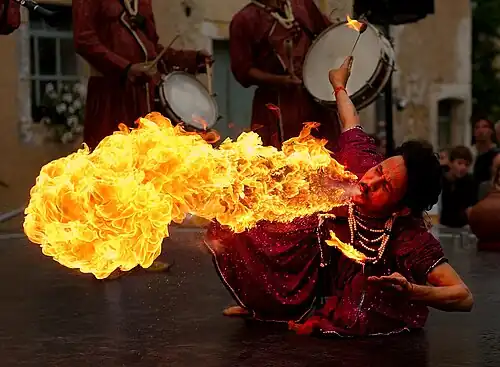 Image 13 Fire breathing Photo credit: Luc Viatour A fire breather in the "Jaipur Maharaja Brass Band" of India. Fire breathing, which is said to have originated in India, is the act of creating a large flame by spraying, with one's mouth, a flammable liquid upon an open flame. A number of legendary creatures are said to possess innate capabilities for fire breathing, most notably dragons. More selected pictures