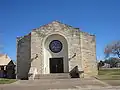 The architecture of the First Baptist Church resembles a fort or other western structure.