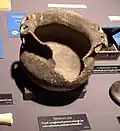 A storage pot with an unknown animal as effigy handles