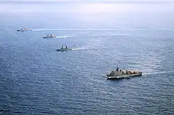 From top left, the guided missile destroyer USS John S. McCain (DDG-56); the Philippine frigates BRP Gregorio del Pilar (FF-15) and BRP Ramon Alcaraz (FF-16); and the amphibious dock landing ship USS Ashland (LSD-48) while in formation during CARAT Philippines 2014.
