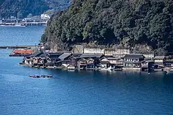 The Funaya built on the small stretch of flat land between the steep mountains and the sea.