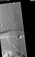 Graben in the Memnonia Fossae, as seen by HiRISE. This graben is believed to be the result of magmatic dikes rather than regional tectonic stretching (scale bar is 1.0 km).