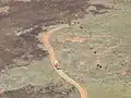 Grader opening a fireline by taking the fuel off the edge, followed by heavy duty fire appliance (HD156) in charge of its protection and avoiding hop overs. ESP001 bushfire at Mundrabilla, October 2011.