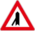 Joining the side road at a sharp angle to the left
