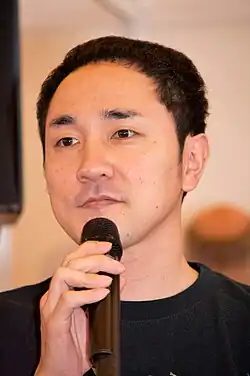 Hiroshi Matsuyama, holding a microphone
