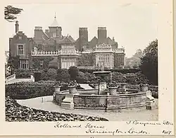 A garden with a fountain on the house's west side