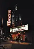 Exterior at night with neon sign illuminated (2011)
