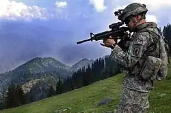 A soldier wears the 173rd Airborne Brigade Combat Team SSI on his ACU uniform while serving in Afghanistan
