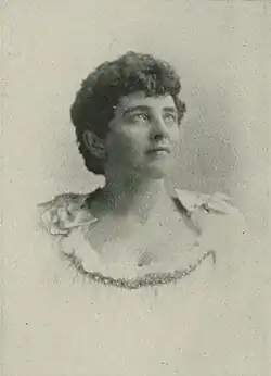 B&W portrait photo of a young woman with short hair looking upwards.