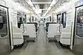 Interior of 209-2100 series car with transverse seating in 20 August 2023