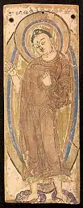 Kizil First Period 300-395 CE. Tocharian inscription: "The Buddha was painted by the hand of Ratna(...)".[72]