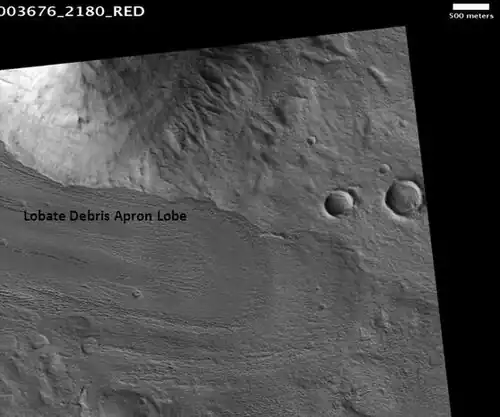 Lobate debris apron in Phlegra Montes, as seen by HiRISE. The debris apron is probably mostly ice with a thin covering of rock debris, so it could be a useful source of water. Scale bar is 500 meters long.