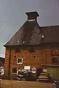 Maltings at brewery being used for car repairs late 1970s
