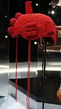 Royal headdress called Orikogbofo were lighter versions of ancestral crowns, which were often heavy and cumbersome. The orikogbofo fulfilled the function of keeping the Oba's head always covered, for it was taboo for an Oba to be seen bare headed. This style is now popular across southern Nigeria worn by various royals in the region. Remnant tassels of a beaded veil that should completely shield the Oba's face has been extensively reduced to a few convenient strings.