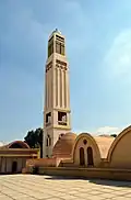 The monastery's lone lighthouse with the domes of the Anba Makar church next to it.