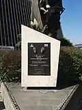 An urn with a plaque honoring Arena Betancourt: "Icon of the Antioquian people and a great sculptor of America".