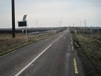 Narrow gauge bog railway crossing R502 near Derrygreenagh (geograph 4848511).jpg