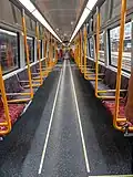 NGR (refurbished) MA Carriage longitudinal seating with priority seats coloured red.