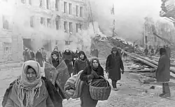 Image 6Residents of Leningrad leave their homes destroyed by German bombing. About 1 million civilians died during the 871-day Siege of Leningrad, mostly from starvation. (from History of the Soviet Union)