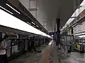 Passengers alighting from a train at the platform.