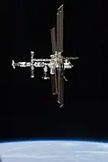 Full starboard side view of the station as Atlantis begins its half-loop fly-around