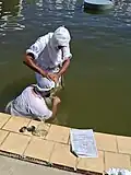 Rishama Salah Choheili performing masbuta for a Mandaean at Wallacia Mandi during Parwanaya 2025