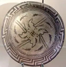 The Samarra bowl, from Iraq, circa 4,000 BCE, held at the Pergamonmuseum, Berlin. The swastika in the centre of the design is a reconstruction.[89]